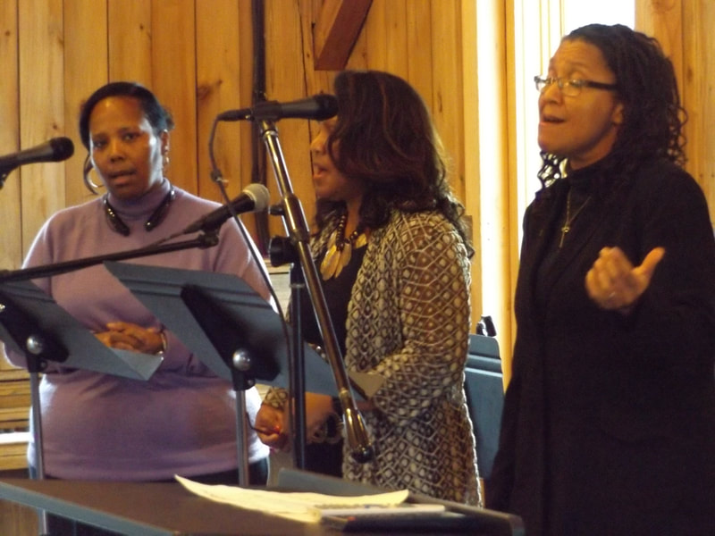 Three women singing.