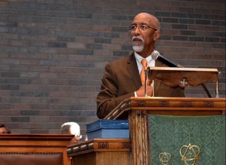 Michael Edgar Myers speaking in pulpit