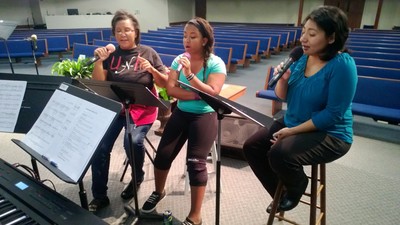 Women's trio rehearsing.